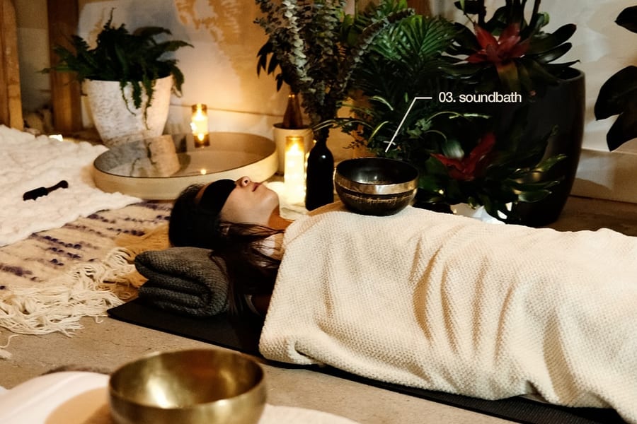Participants resting on yoga mats during sound bath